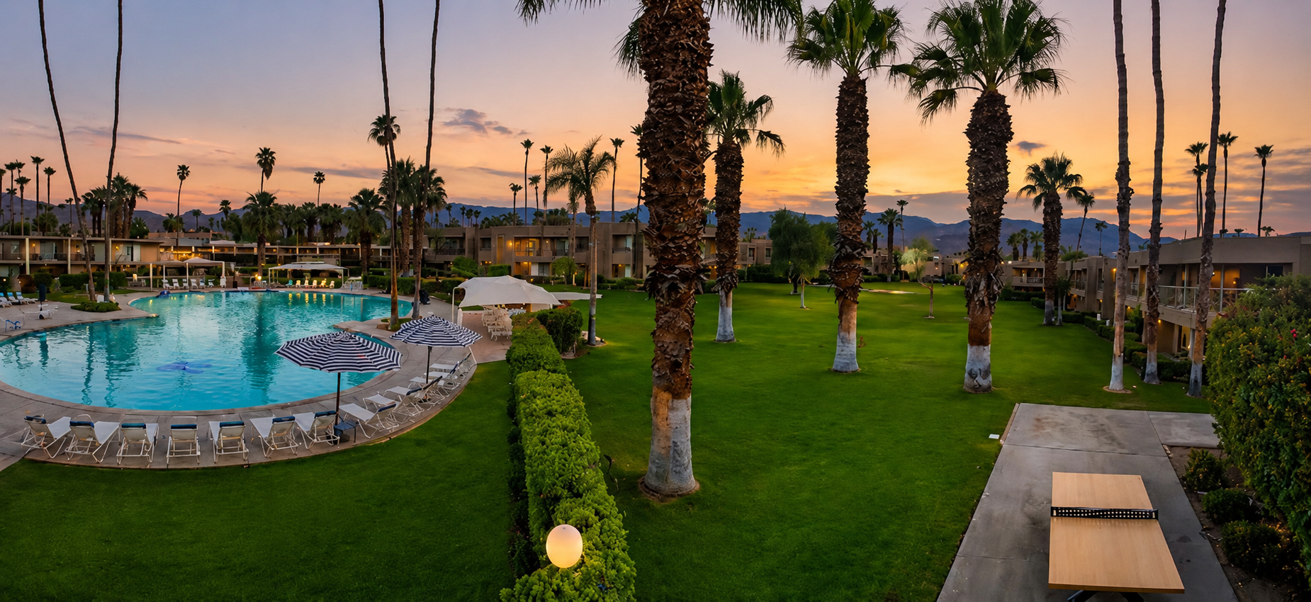 Shadow Mountain Resort at sunset with pool, palm trees, and lawn